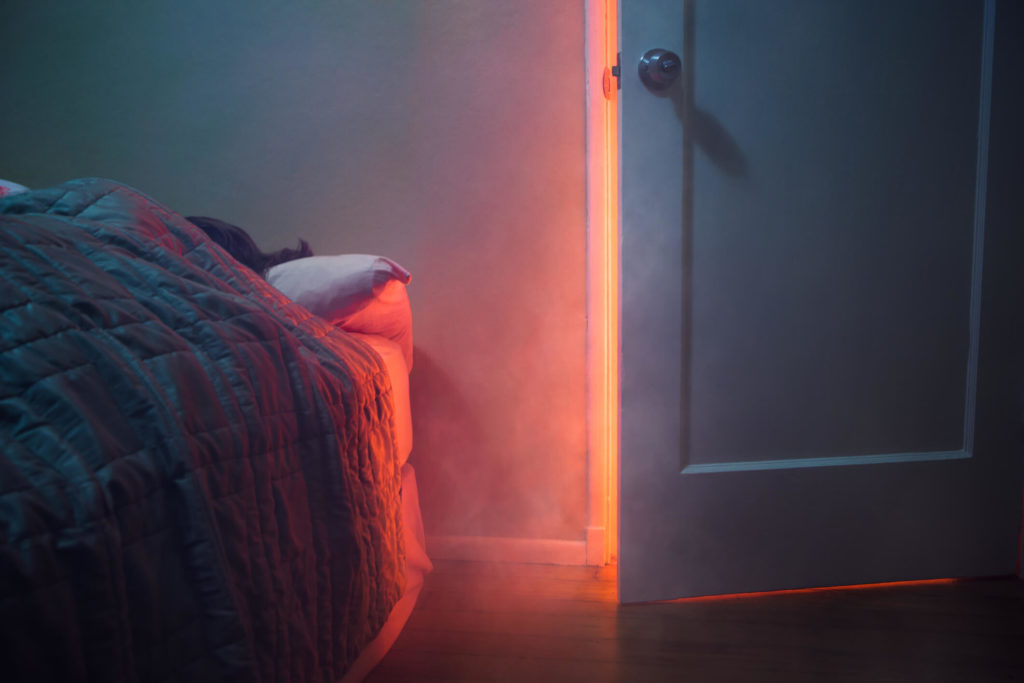 Bedroom with nearby house fire