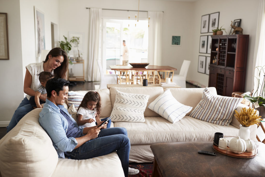 Young family using Cox internet in their living room