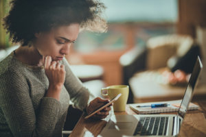 Woman looking at phone while working