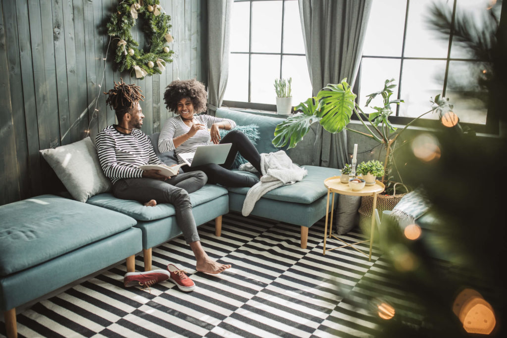 Couple relaxing on couch using Link Interactive