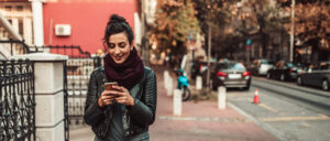 Woman using smartphone near a downtown city street