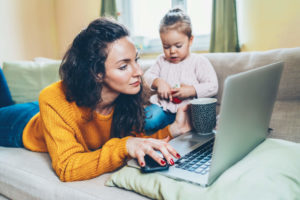 Mother and daughter on laptop setting up internet