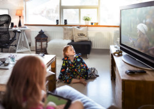 Boy sitting on floor watching Sparklight TV