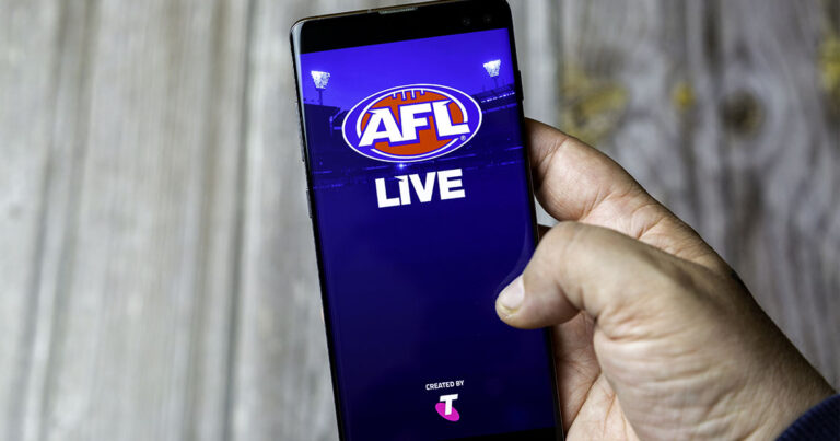 Photograph of someone using the AFL Live app on a smartphone