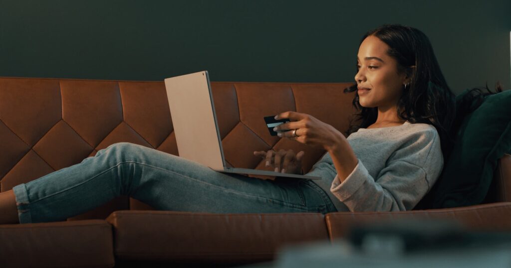Woman paying with credit card for Private Internet Access VPN on Laptop