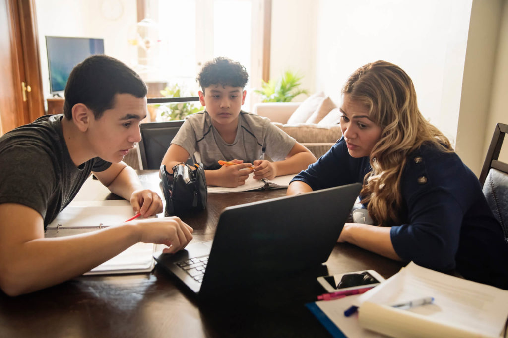 Mother teaching children about internet safety on laptop