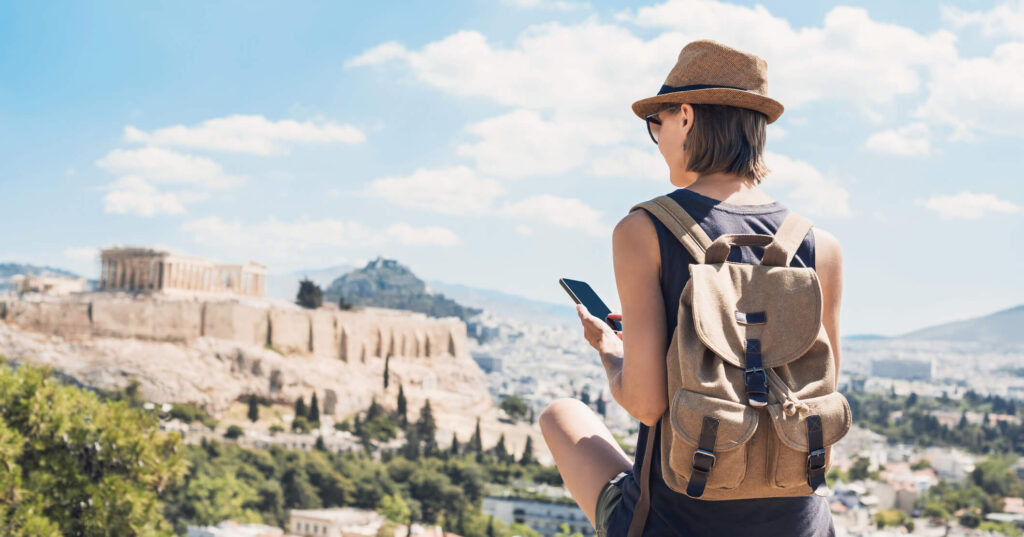 Woman travelling using a smartphone travel SIM
