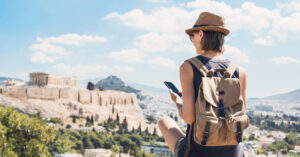 Woman travelling using a smartphone travel SIM