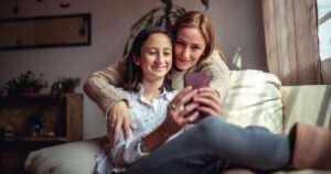 Mom and Daughter Using a Phone
