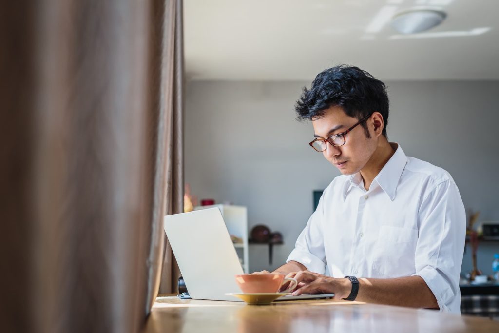 man using computer in his home