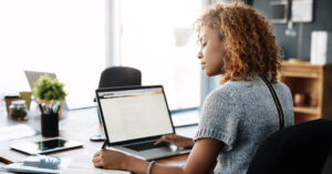 What is a VPN? Stock photograph of a woman using a VPN on her laptop