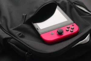 Pink Nintendo Switch in a backpack