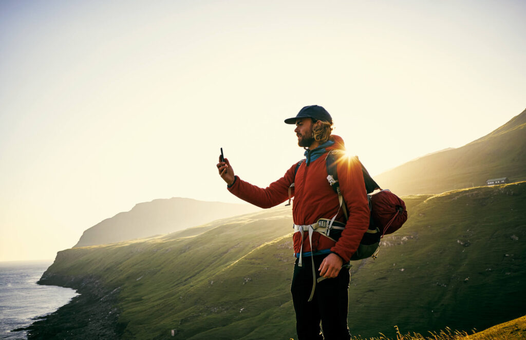 Man Using Phone in the Wilderness