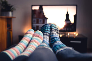 Photo of couples feet in coxy socks in front of TV while watching HBO