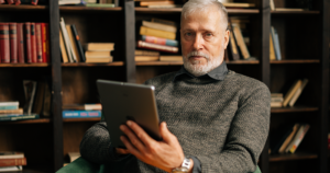 Senior Gentlemen using a tablet to access the Internet