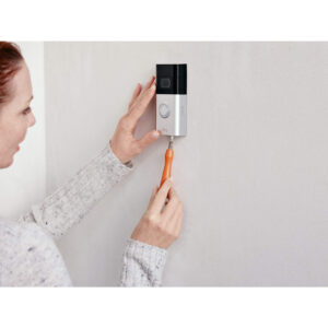 Woman installing a Ring Video Doorbell