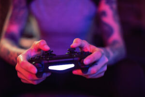 A female gamer games with a PlayStation controller