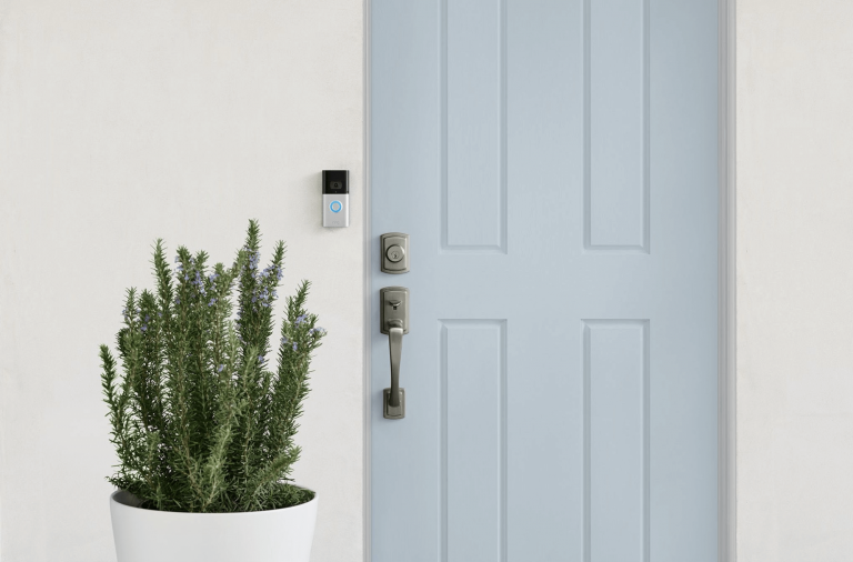 Ring Video Doorbell 3 Plus installed next to a light blue front door and a potted plant