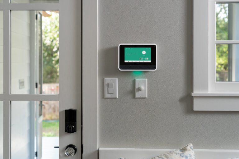 Vivint Smart Hub mounted on a white wall near a glass door