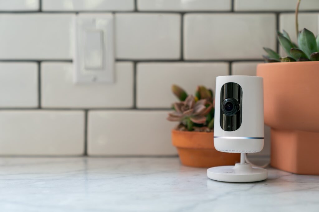 Vivint Indoor Camera on marble countertop near some plants
