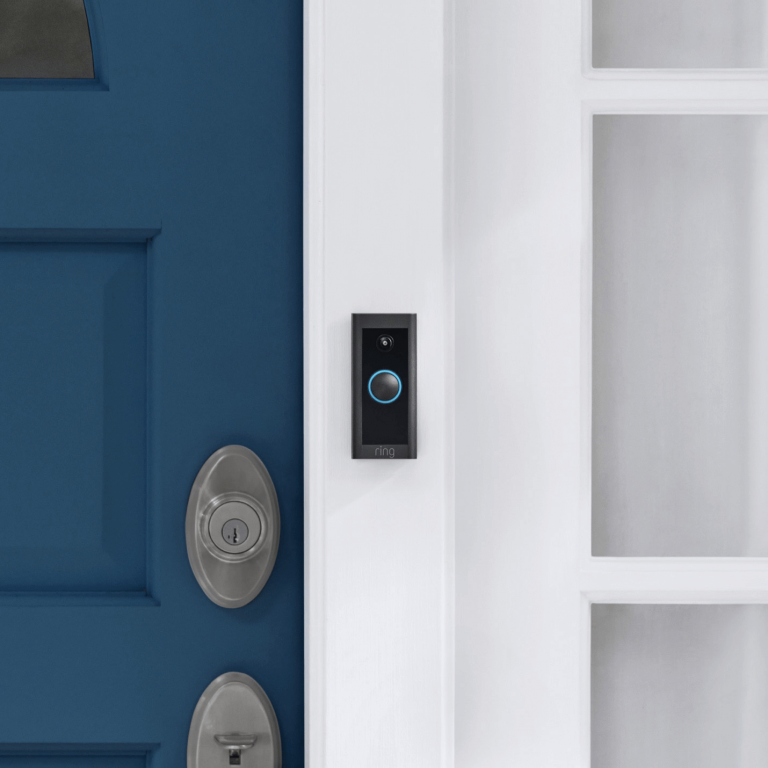 Ring Video Doorbell Wired installed next to a blue front door