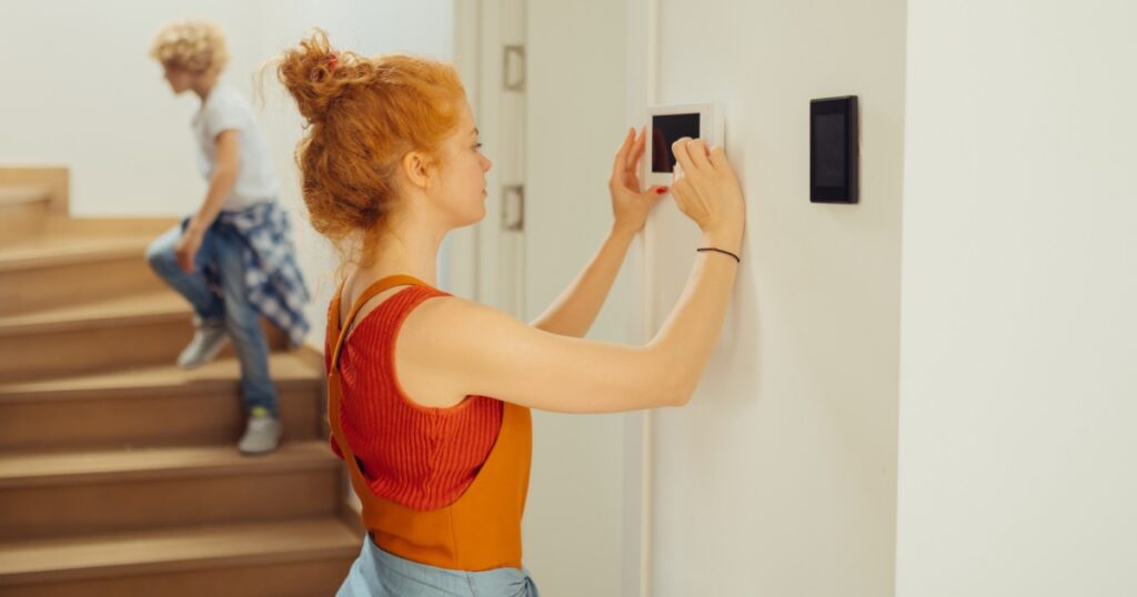 Woman installing a control panel