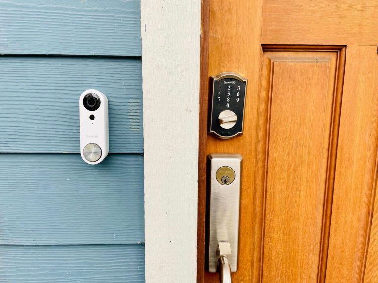 SimpliSafe Doorbell Camera Pro shown installed on a house next to a front door