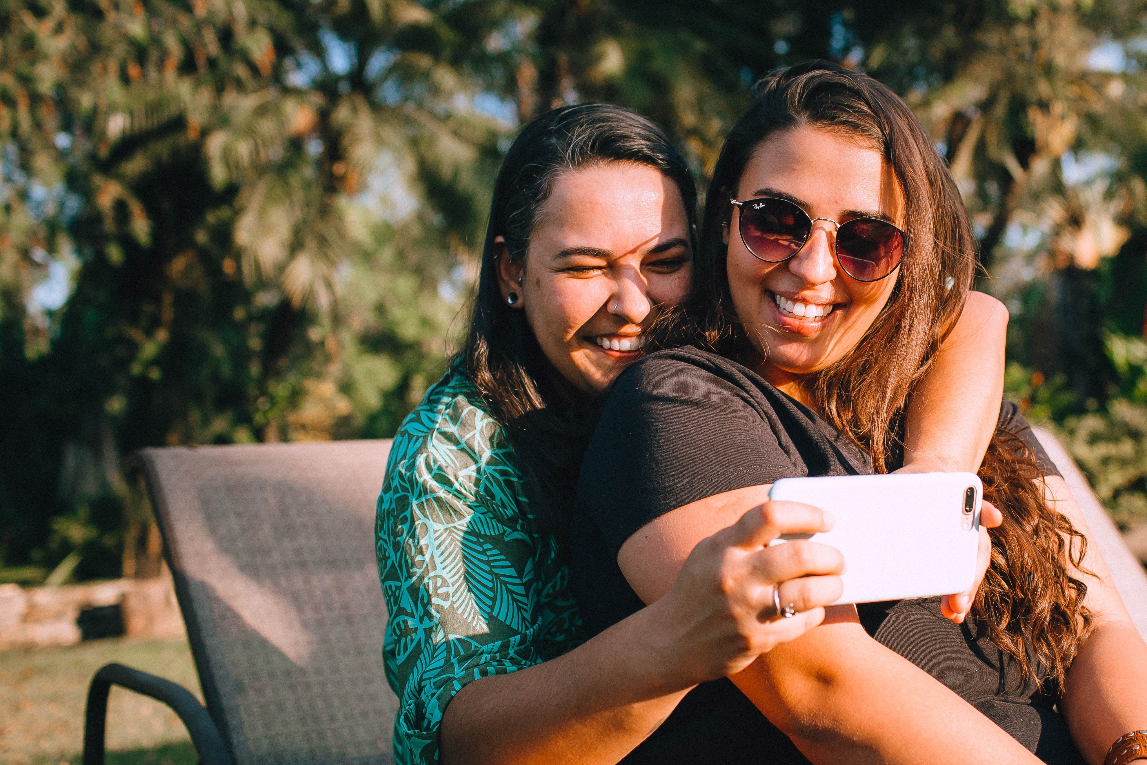 two girls taking a selfie on an iphone - Circles.Life sale