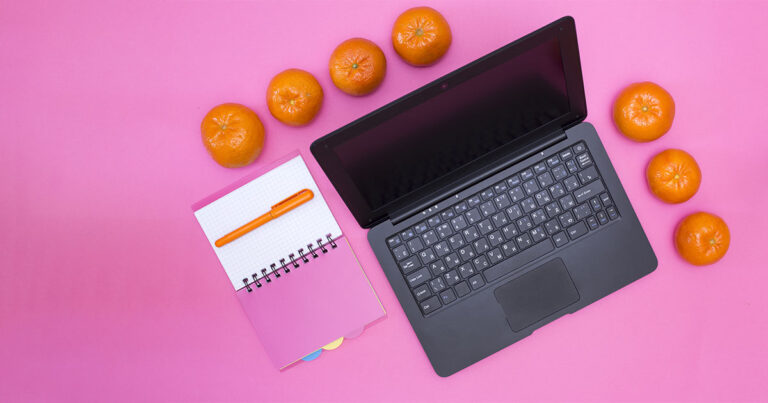 Photograph of a laptop using NBN internet surrounding by Tangerine