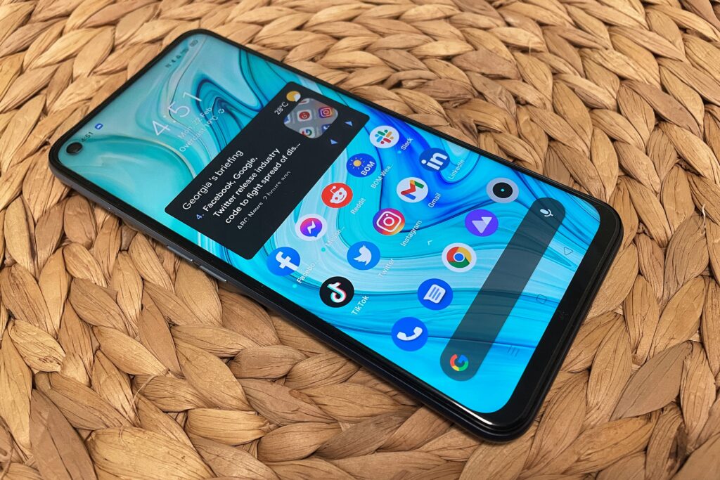 Realme 7 5G smartphone on a rattan table