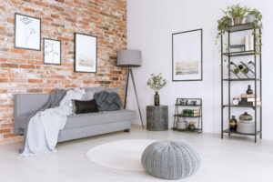 Stylish living room with a gray couch against a brick wall
