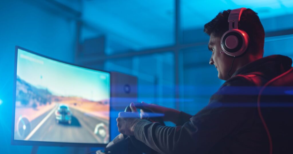 Photograph of a man playing a racing game with superfast NBN internet