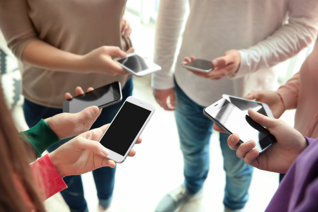 group of people holding iPhones