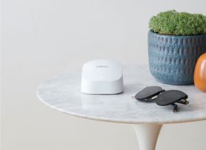 Eero device on table with sunglasses