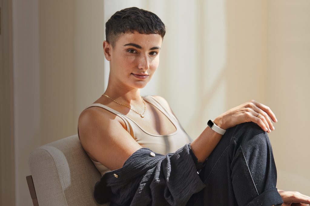 a short-haired brunette woman wearing the new Fitbit Luxe