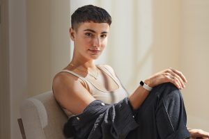 a short-haired brunette woman wearing the new Fitbit Luxe
