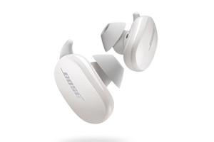 A close-up of white Bose QuietComfort earbuds