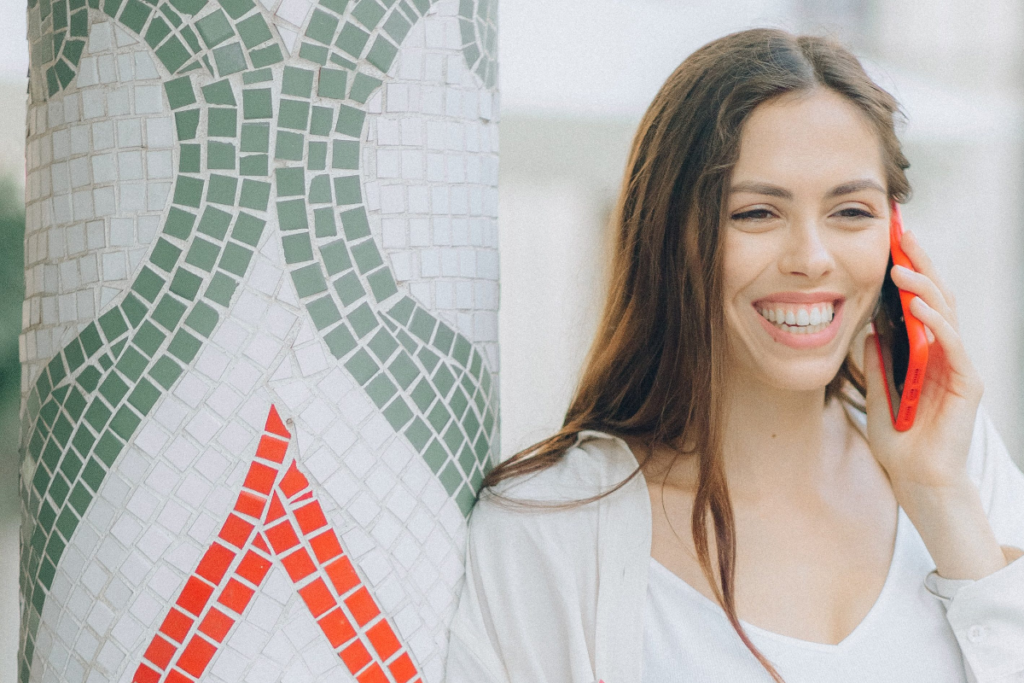 A young brunette woman using an unlocked Telstra phone