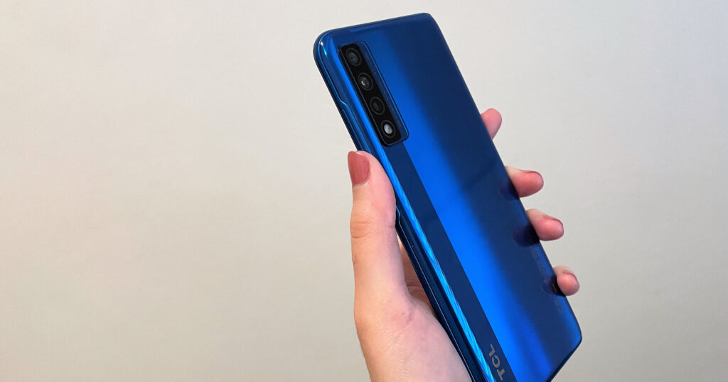 Woman's hand holding a TCL 20 5G smartphone in Placid Blue