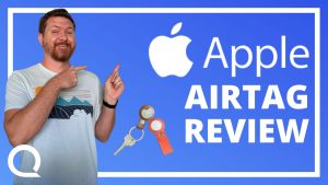 A man pointing at Apple logo and text "Apple Airtag Review" next to a key on a keychain.