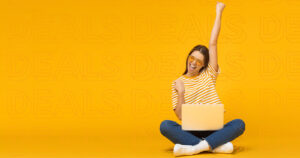 Stylised photograph of woman on laptop smiling and cheering