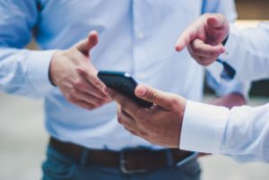 Business dudes looking at a smartphone