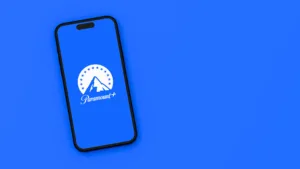 Paramount Plus logo on a smartphone on a flat blue background
