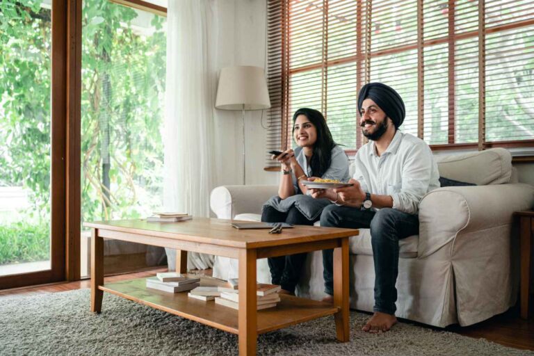 a sikh couple watching tv