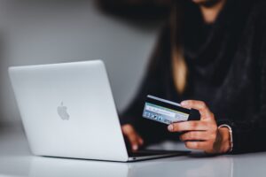 woman shopping on her laptop with her credit card