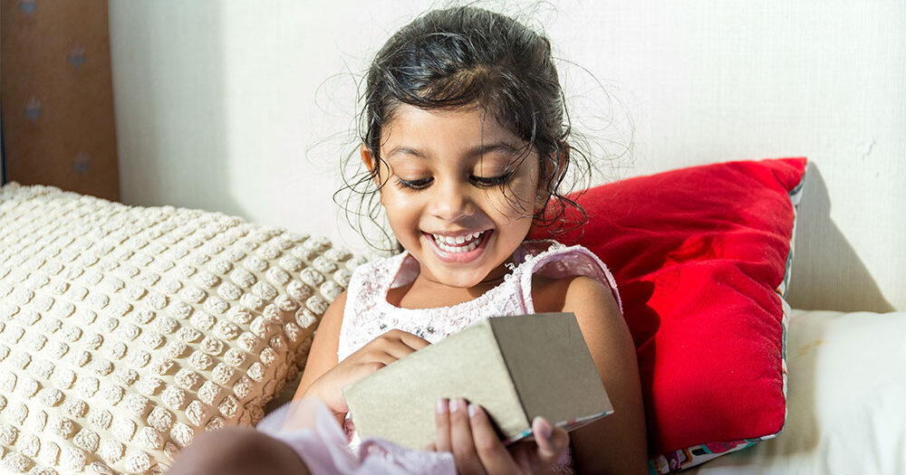 Child looking happy opening gift