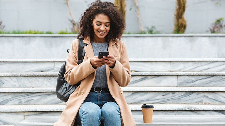 Woman looking at phone and smiling