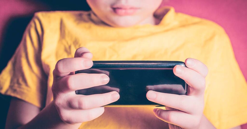 Photo of a kid using a smartphone