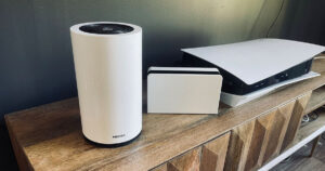 Photograph of Optus 5G Home Modem next to Nintendo Switch and PS5