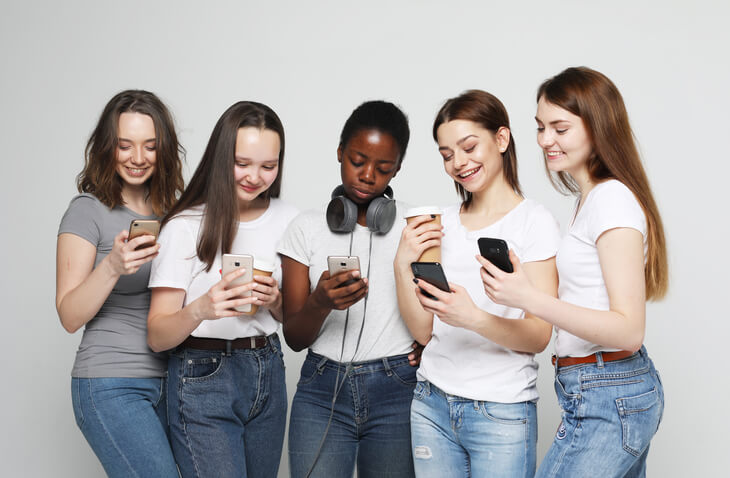 Teenage girls with a variety of phones